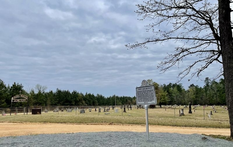 Marker with the Cross Roads Cemetery in background. image. Click for full size.
