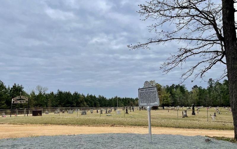 Marker with the Cross Roads Cemetery in background.. Click for full size. Marker with the Cross Roads Cemetery in background. image. Click for full size.