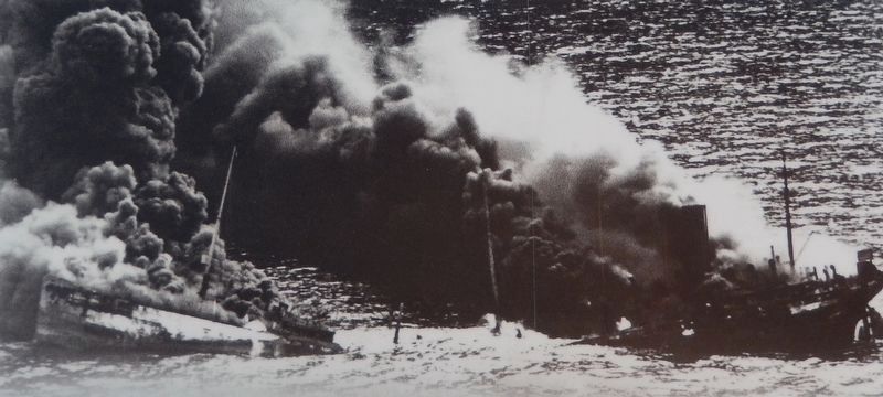 Marker detail: A tanker burns furiously after being struck by a torpedo. Click for full size. Marker detail: A tanker burns furiously after being struck by a torpedo image. Click for full size.