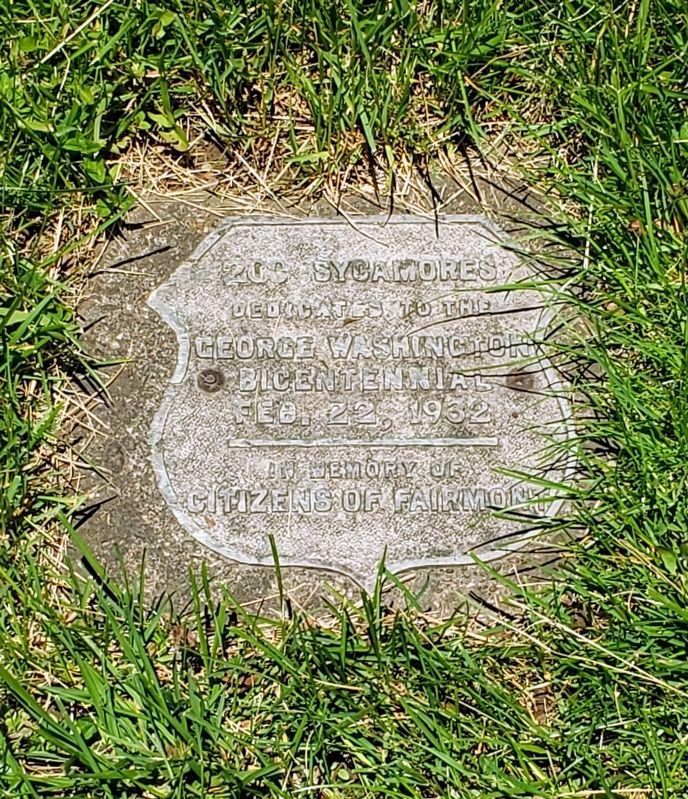 This plaque is embedded in the ground nearby. image. Click for full size.
