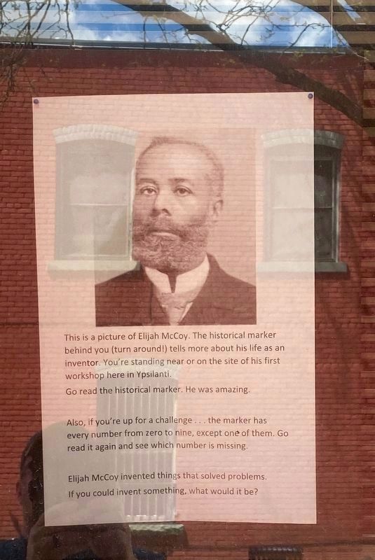 Photo of Elijah McCoy in library window facing marker. image. Click for full size.