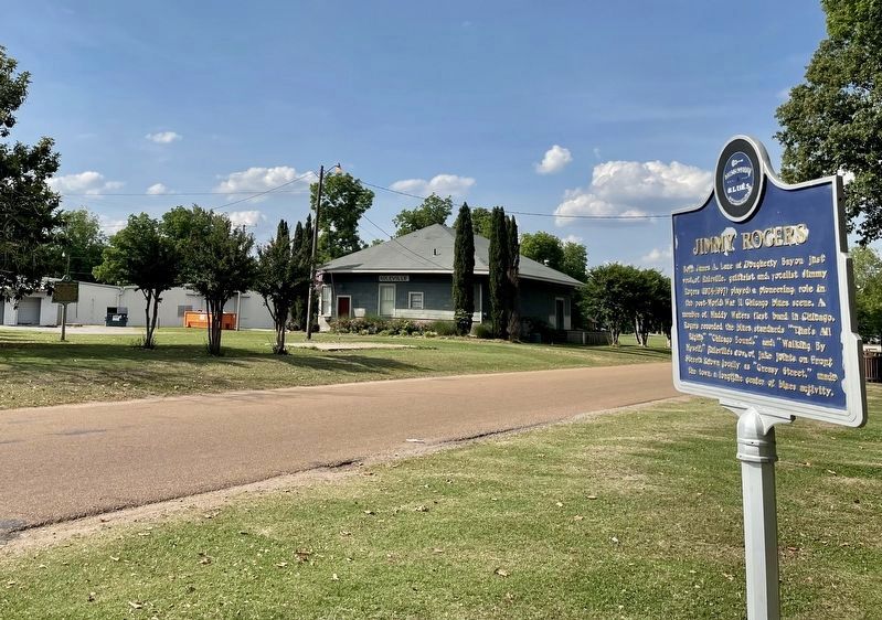 View of Jimmy Rodgers marker with old Ruleville Depot in background. image. Click for full size.