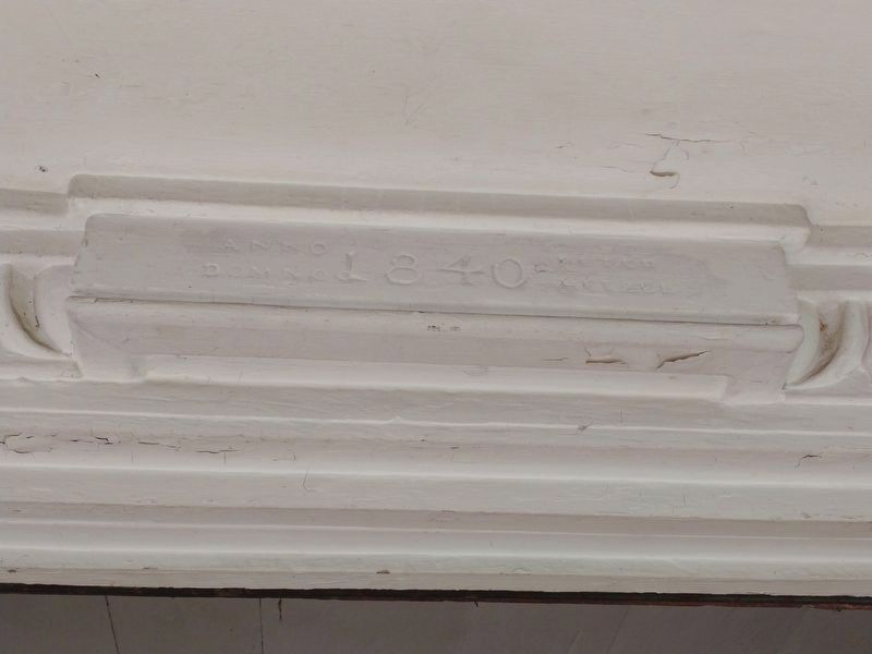At the top of the door frame as you enter the building. image. Click for full size.