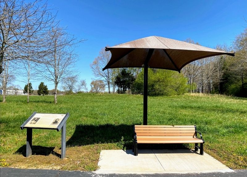 Marker is located next to a bench with a canopy. image. Click for full size.