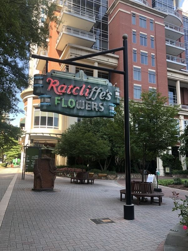 Ratcliffe's Flowers sign with the marker set into the sidewalk beneath image. Click for full size.