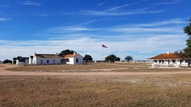 A view of Fort McKavett’s parade grounds with the headquarters building on the right image. Click for full size.
