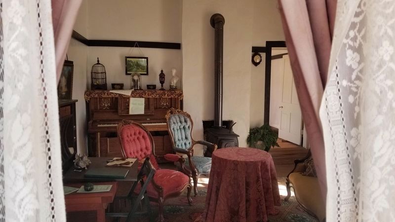 A view through the window of the officer’s house with a lot of furniture image. Click for full size.