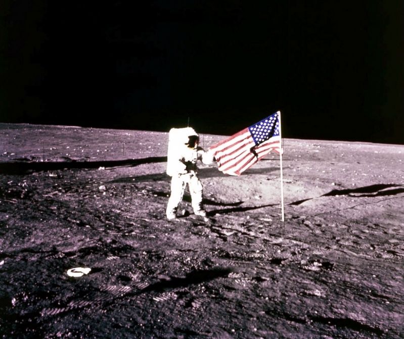 Pete Conrad standing by US Flag on the Moon image. Click for full size.