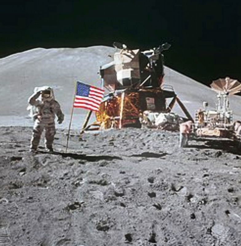 James Irwin salutes the United States flag on the Moon image. Click for full size.