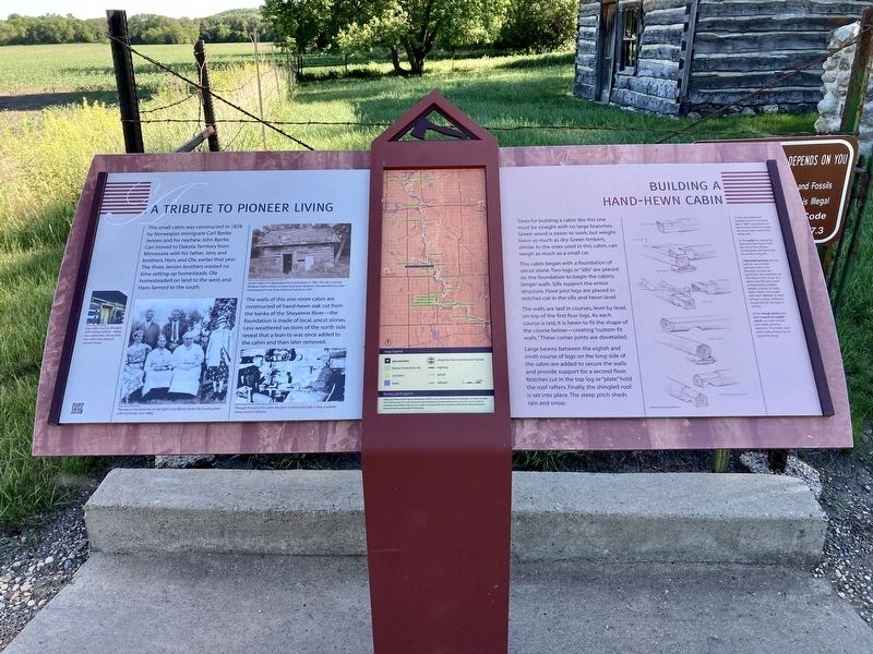 A tribute to pioneer living/Building a hand-hewn cabin Marker. Click for full size. A tribute to pioneer living/Building a hand-hewn cabin Marker image. Click for full size.