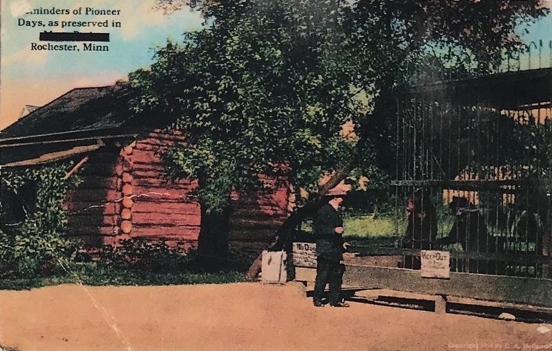 The William Dee Log Cabin, next to a black bear exhibit image. Click for full size.