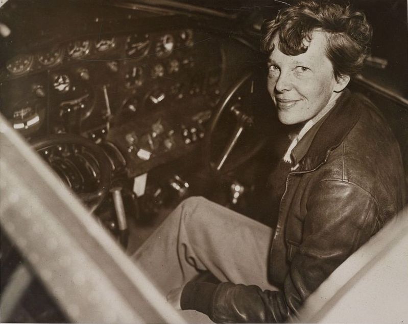 Amelia Earhart sitting in the cockpit of an Electra airplane image. Click for full size.