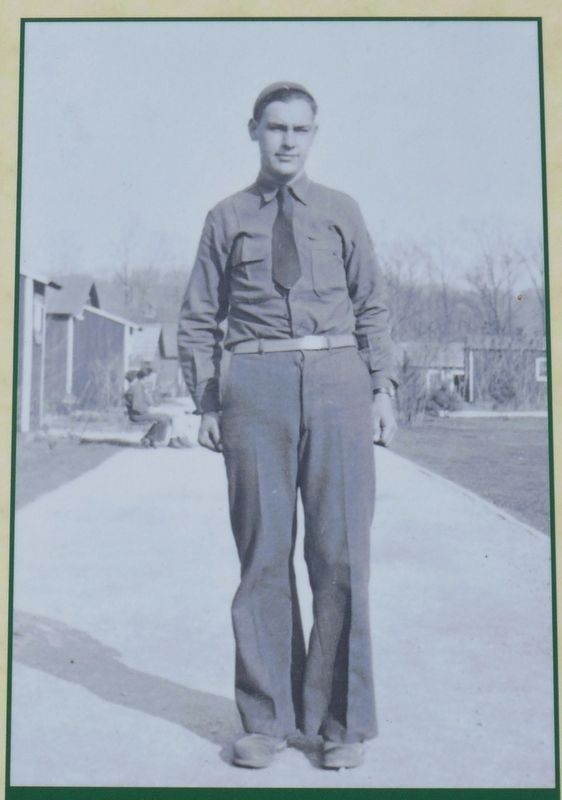 Enrollee Robert Kirkland poses in his CCC uniform along one of the Lower Falls Camp's streets in 193 image. Click for full size.