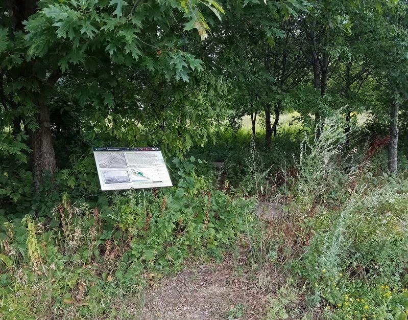 Marker alongside a little-used trail at the southeast end of the concrete pads image. Click for full size.