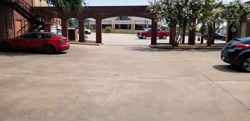 The bronze marker on the ground in the parking lot image. Click for full size.