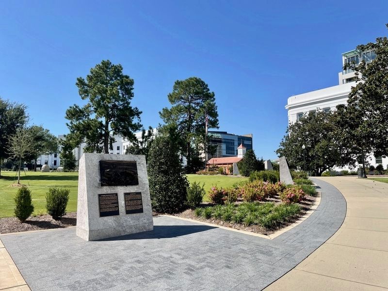 Marker is in the distance above the bush. image. Click for full size.