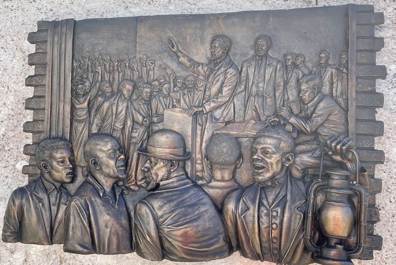 Closeup of bronze relief sculpture on the granite stone. image. Click for full size.