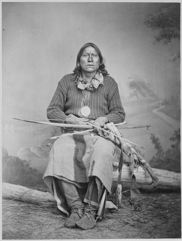 White Bear (Sa-tan-ta), a Kiowa chief; full-length, seated, holding bow and arrows image. Click for full size.