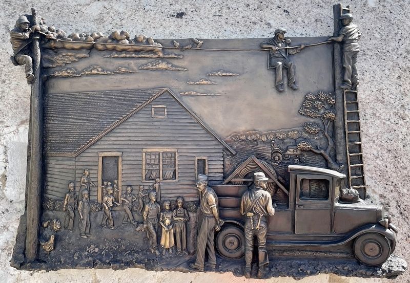 Closeup of bronze relief sculpture on marker. image. Click for full size.