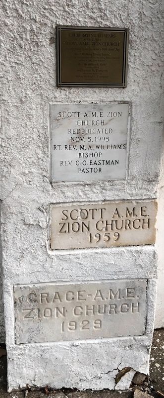 Plaques on the church building with the cornerstone image. Click for full size.