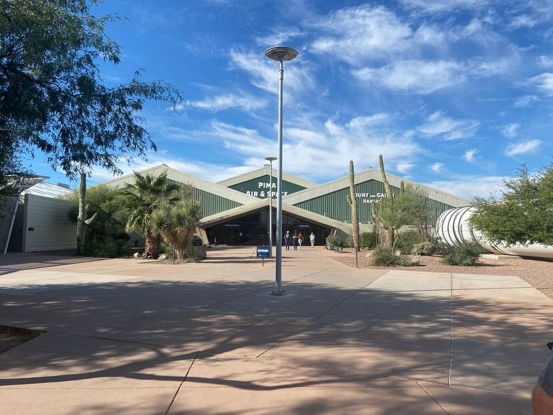 The entrance to the Pima Air & Space Museum next to the booster image. Click for full size.