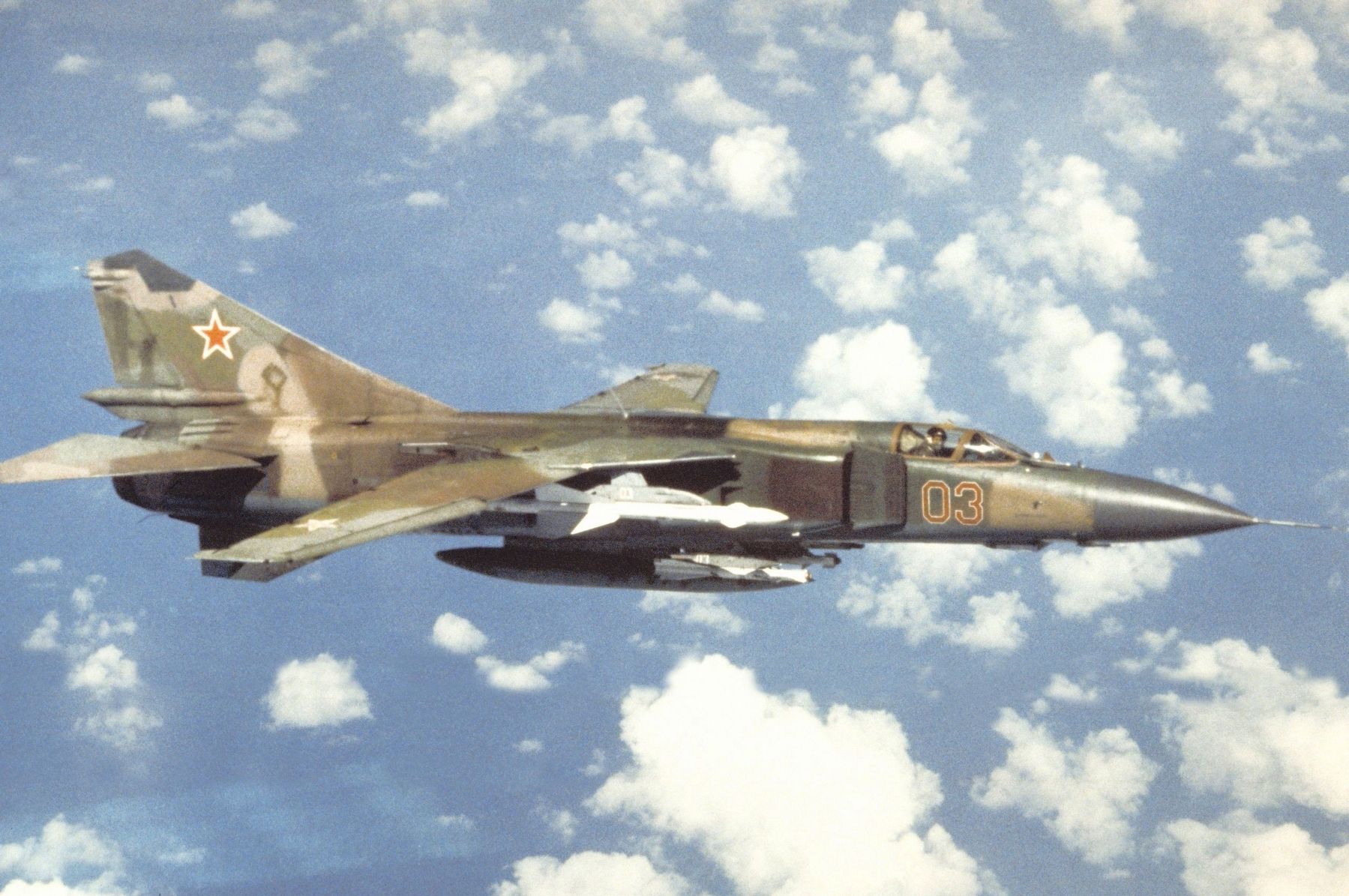 An air-to-air right side view of a Soviet MiG-23 Flogger aircraft image. Click for full size.