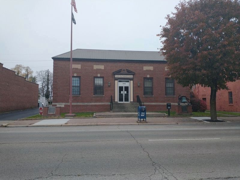 Old Central School Bell display stands in front of the old school image. Click for full size.
