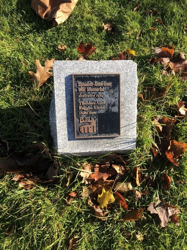 Informational plaque on the ground in front of the memorial image. Click for full size.