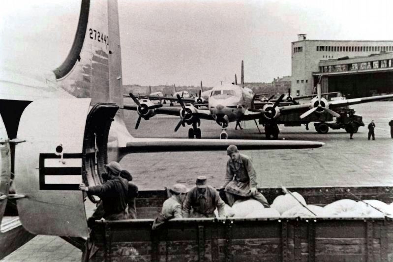 Unloading planes at Tempelhof airport during the Berlin Airlift image. Click for more information.