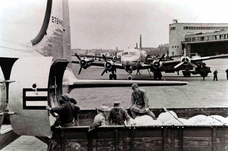 Unloading planes at Tempelhof airport during the Berlin Airlift. Click for more information. Unloading planes at Tempelhof airport during the Berlin Airlift image. Click for more information.