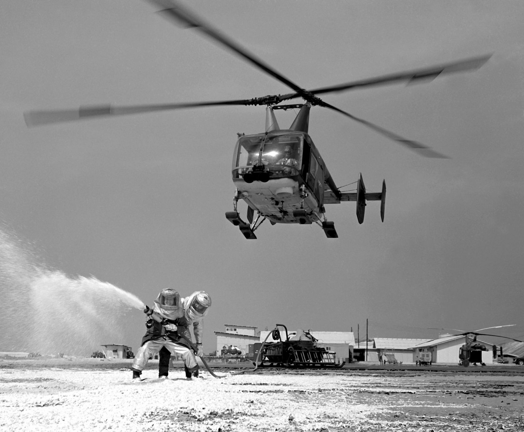 HH-43B Huskie helicopter hovers overhead image. Click for full size.