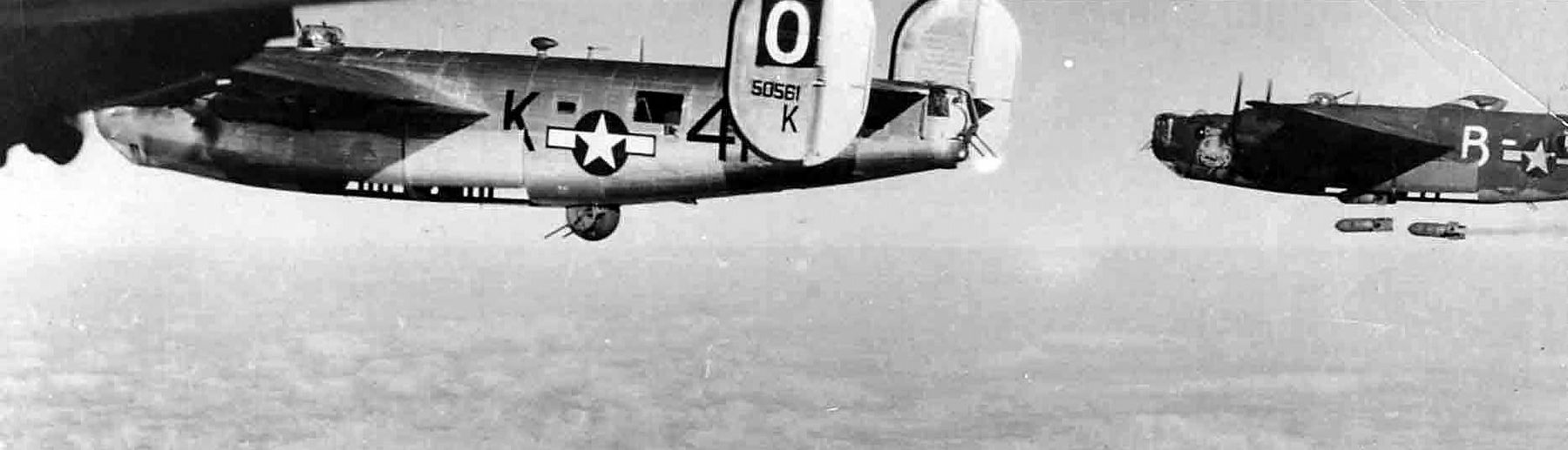 B-24J s/n 42-50561 of the 486th Bomb Group, 833rd BS code 4N-K, dropping bombs image. Click for full size.