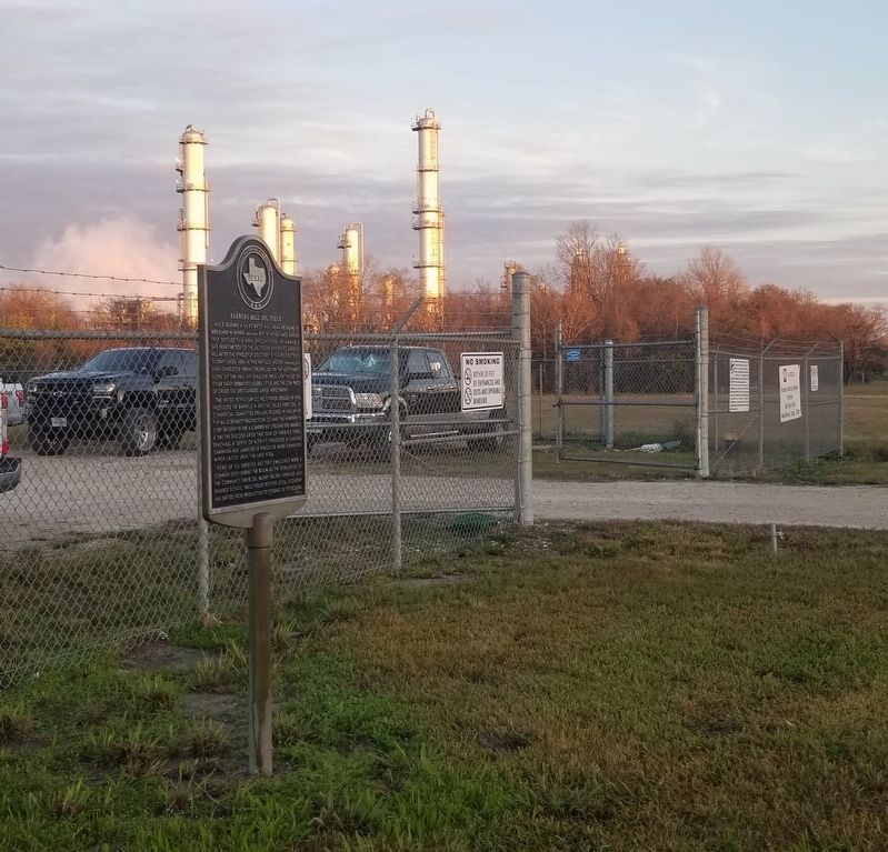The Barbers Hill Oil Field Marker next to a business image. Click for full size.