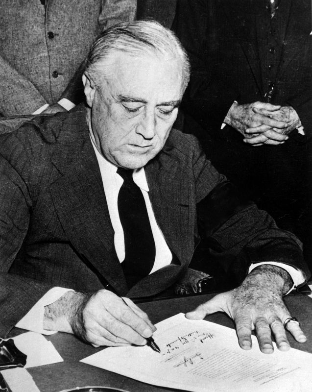 Franklin Roosevelt signing declaration of war against Japan image. Click for full size.