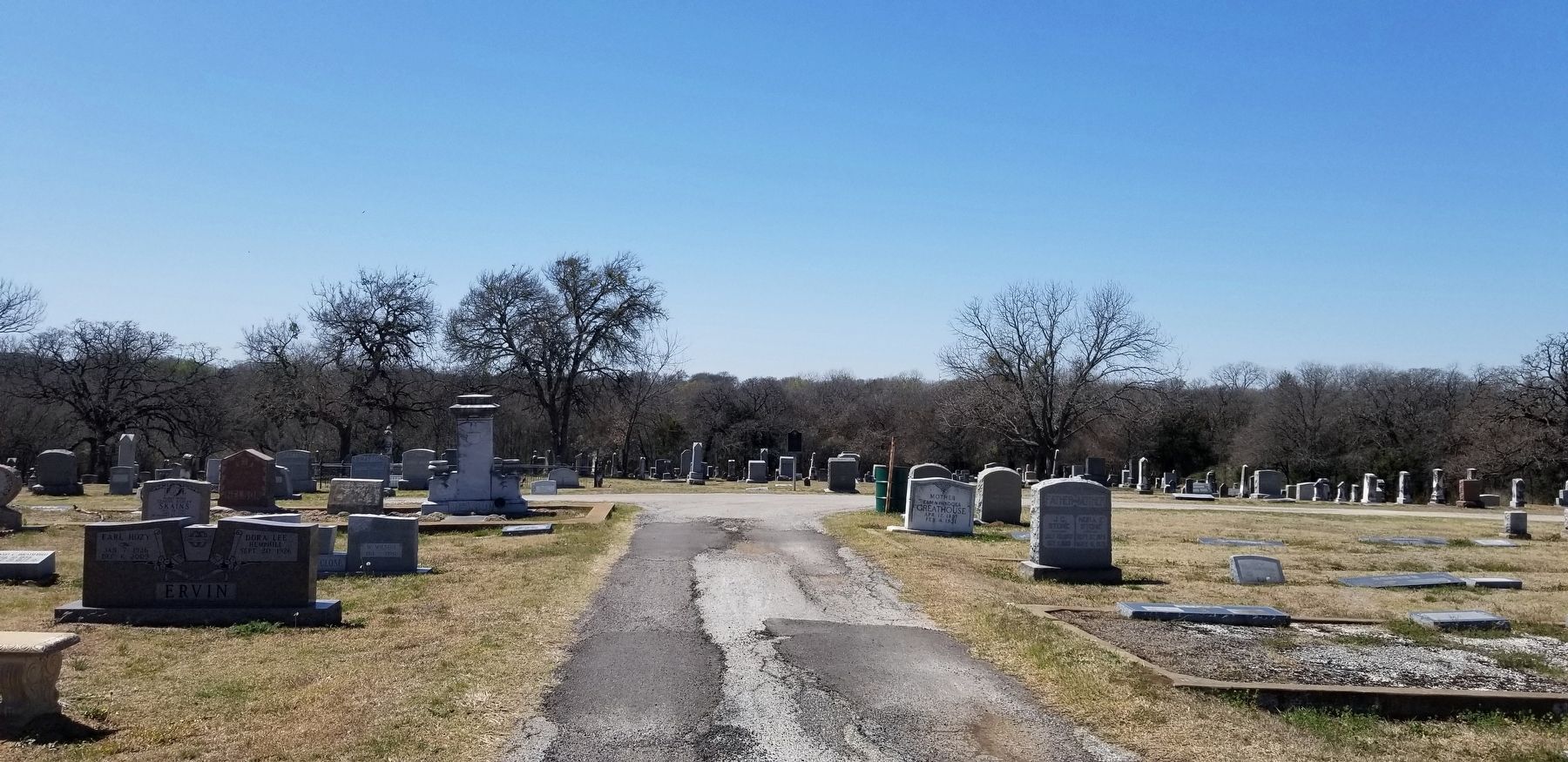 The view of the marker driving east down the main cemetery road image. Click for full size.