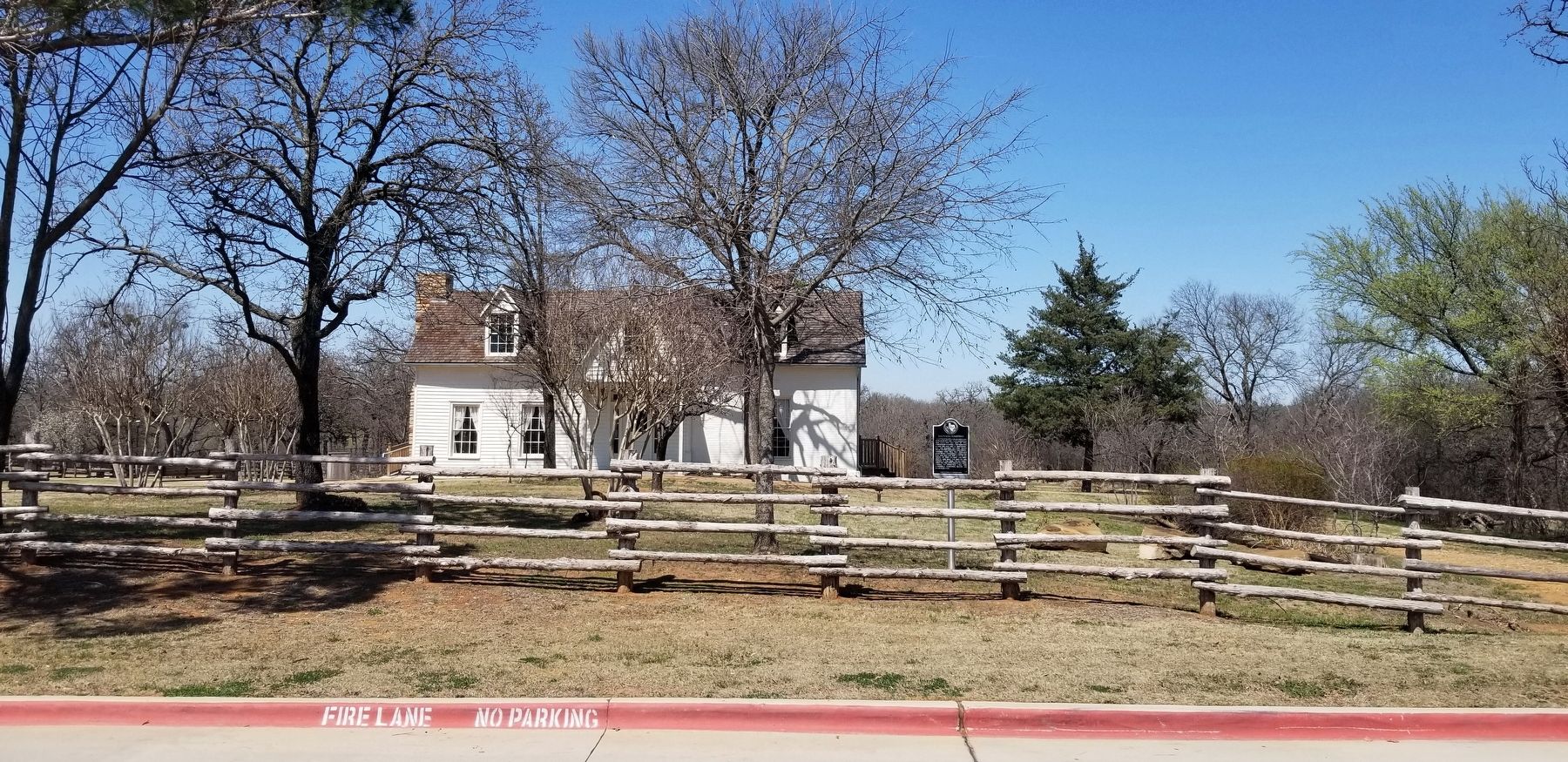 The view of the Ralph Man Homestead and Marker from the driveway to the city park image. Click for full size.