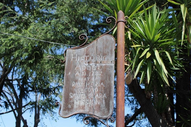 Wooden marker at the front garden wall. image. Click for full size.