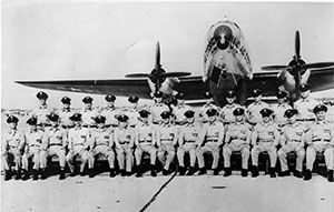 Members of the 435th Troop Carrier Wing posing with a C-46 Commando. image. Click for full size.