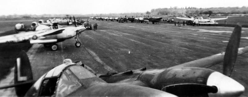 P-38 Lightnings of the 474th Fighter Group lined up on hardstanding. image. Click for full size.
