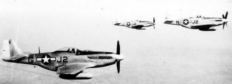 Three P-51 Mustangs of the 479th Fighter Group, fly in combat formation. image. Click for full size.