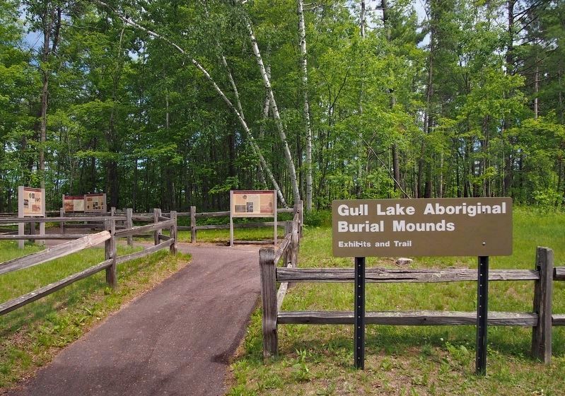 Markers at the trailhead through the mound site image. Click for full size.