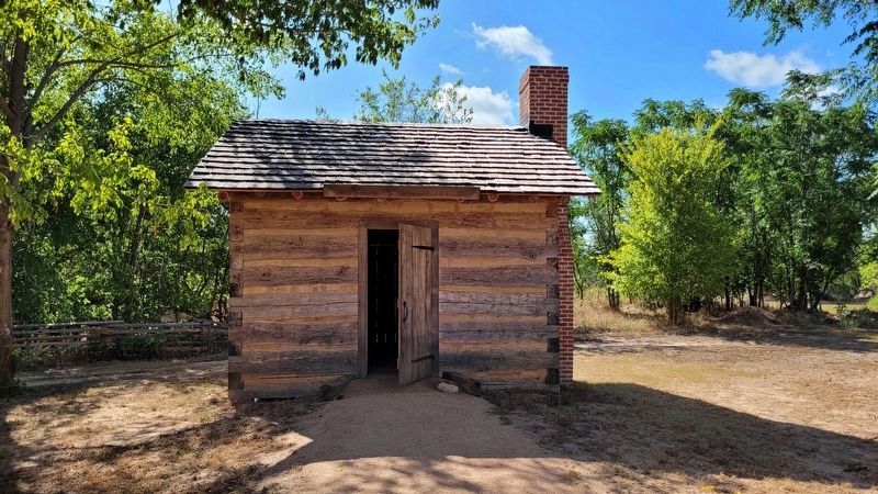 Reproduction of an Emigrant’s Residence on the east side of the historic site image. Click for full size.