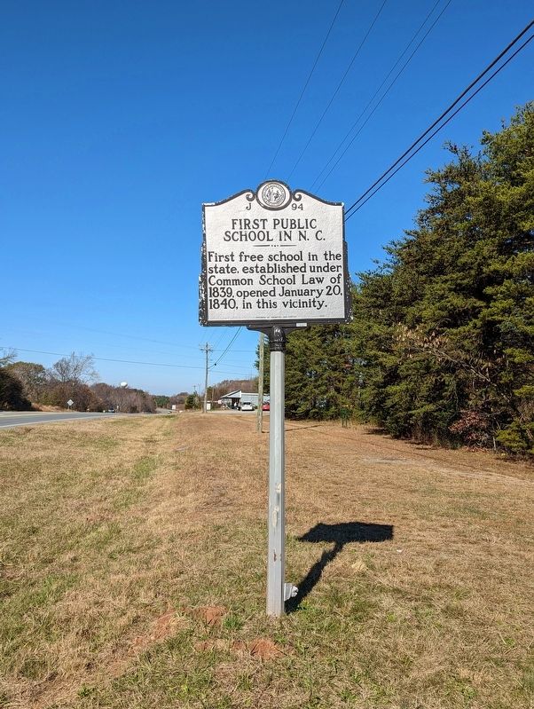 A sign marker stating NC first free public school in 1840
