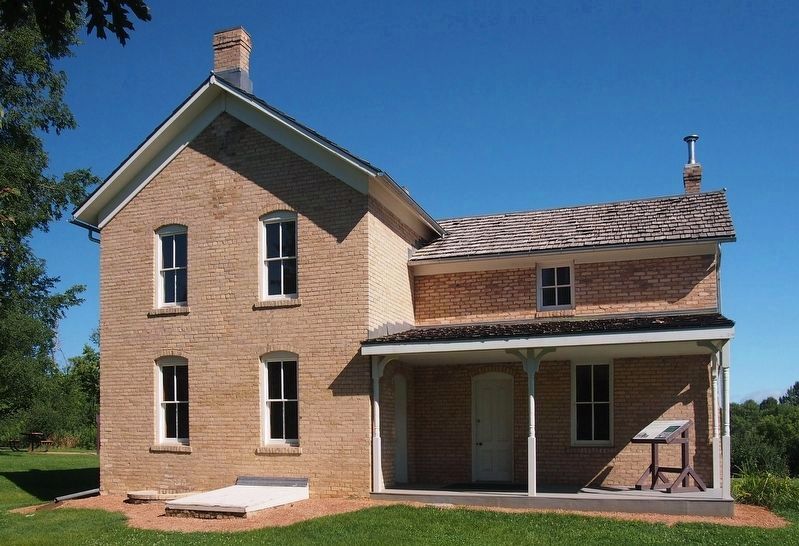 The historic Wendelin Grimm Farmhouse, with the marker on the porch image. Click for full size.