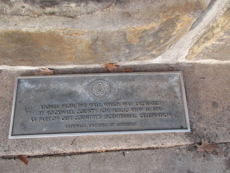 Plaque, at the base of stone wall, below marker image. Click for full size.