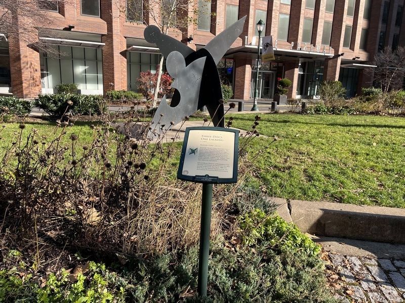 Three Disks, One Lacking Marker with the sculpture visible in the background image. Click for full size.