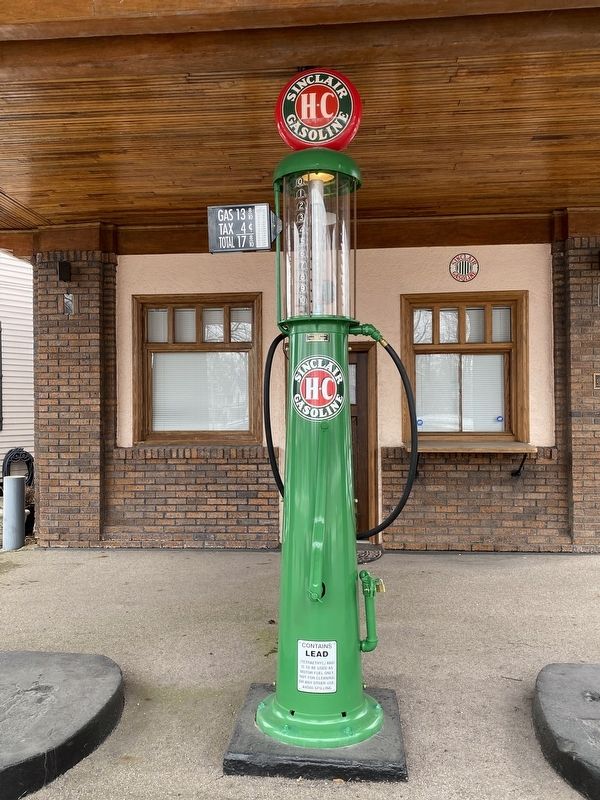 Vintage gas pump in front of the station image. Click for full size.