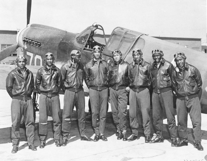 Eight Tuskegee Airmen in front of a P-40 fighter aircraft, circa 1942-3 image. Click for full size.