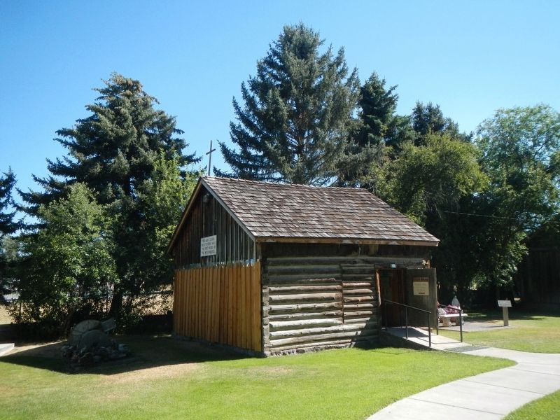 This log cabin. built in 1854, was the first home of the missionaries. image. Click for full size.