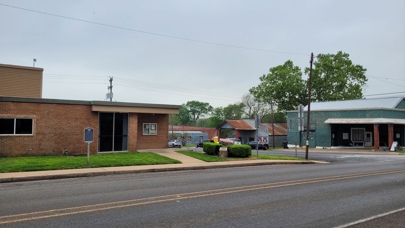 The Texas Pink Granite Rock and Marker are located to the right of the Burton Bank building. image. Click for full size.